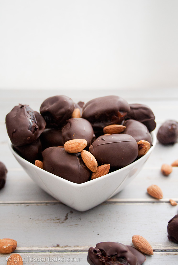 Almond Stuffed Chocolate Covered Dates - sweet, chewy dates stuffed with cinnamon roasted almonds and smothered in rich, dark chocolate. So easy to make and they make the most delicious sweet, healthier snack. You'll LOVE them!