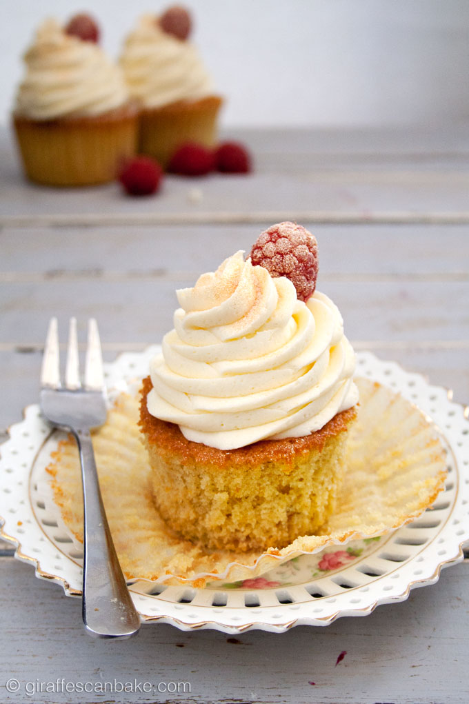 Orange and Raspberry Cupcakes with Prosecco Buttercream Frosting - fluffy, moist zesty orange cakes with raspberries baked into the centre, topped with creamy, fluffy prosecco buttercream frosting! The perfect cupcake for any celebration!