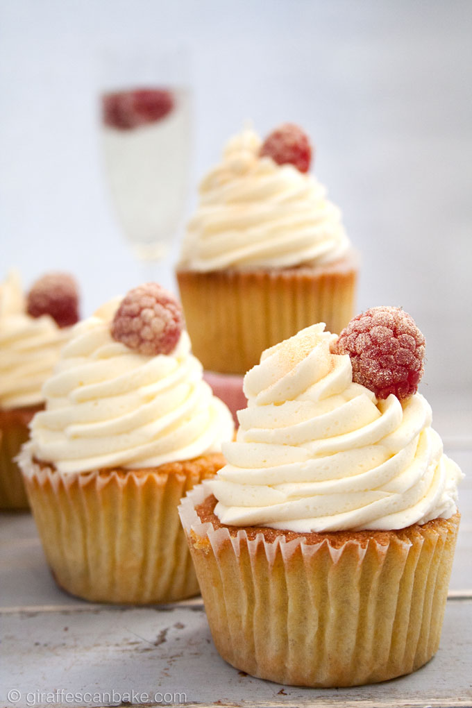 Orange and Raspberry Cupcakes with Prosecco Buttercream Frosting - fluffy, moist zesty orange cakes with raspberries baked into the centre, topped with creamy, fluffy prosecco buttercream frosting! The perfect cupcake for any celebration!